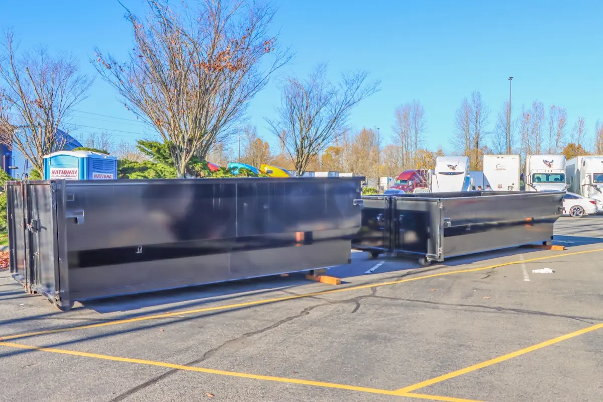 Professional dumpster rental service with roll-off container on residential driveway in Tarboro
